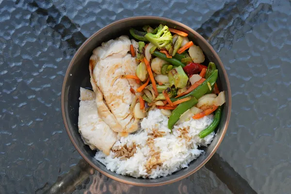 A chicken and vegetable stir-fry over rice